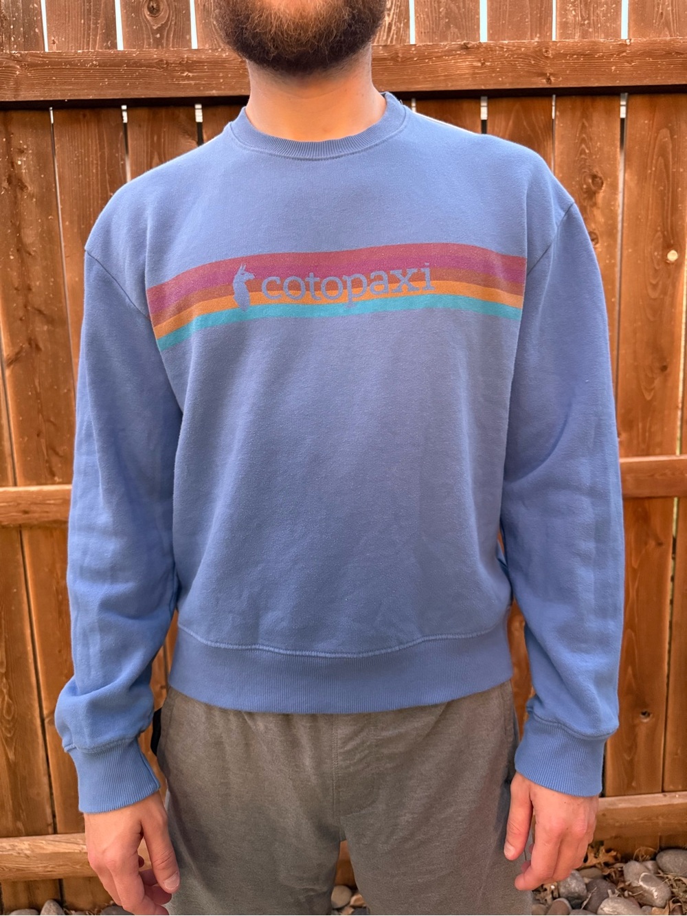 cotopaxi blue crewneck sweater with multicolor stripe logo